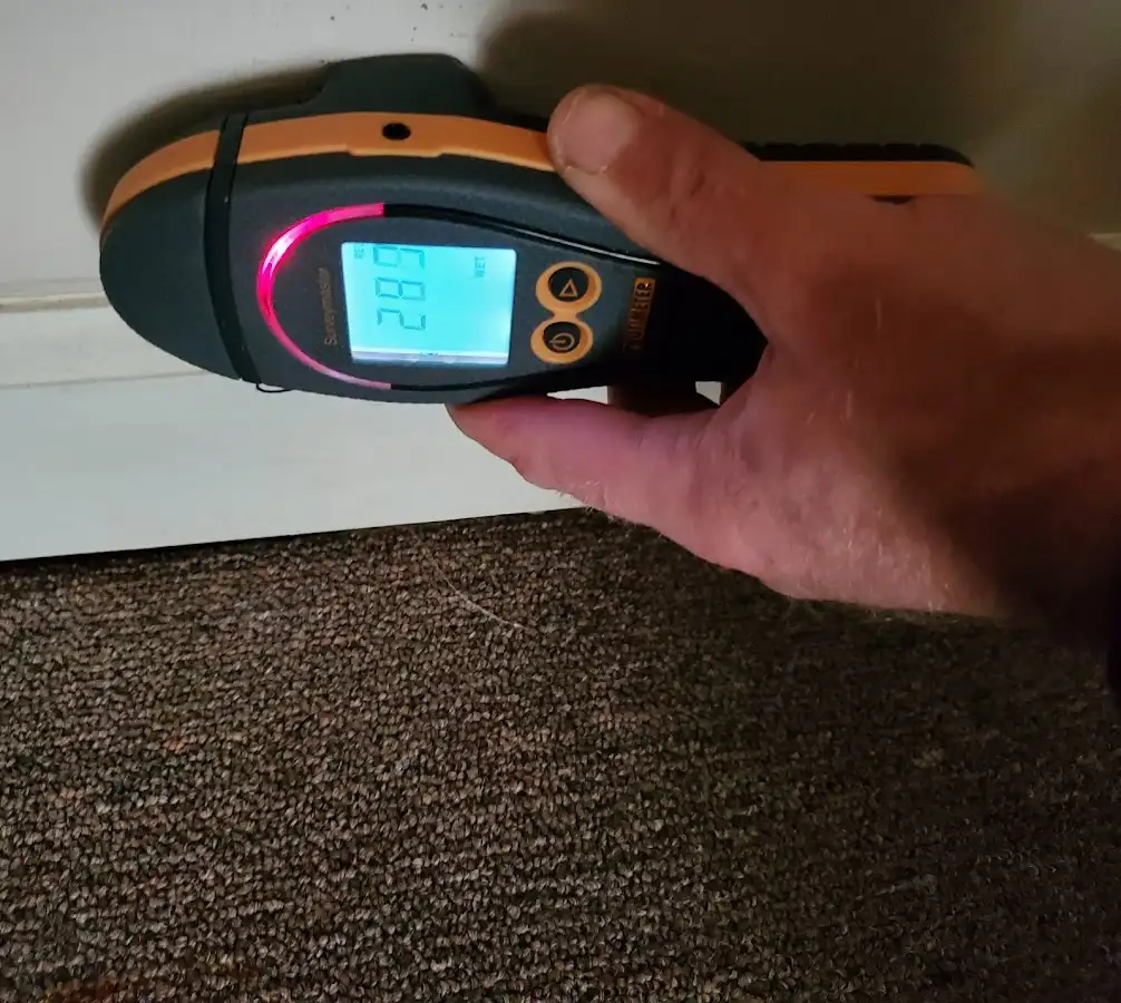 Moisture detection at baseboard during Storm Damage Restoration in Coon Rapids